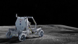 A back view of an artist's rendering of a white unpressurized lunar terrain vehicle developed by Astrolab. You can see the back side view of an astronaut sitting in the passenger seat and the back of the lunar rover has logos of all of the companies who contribute to its development.