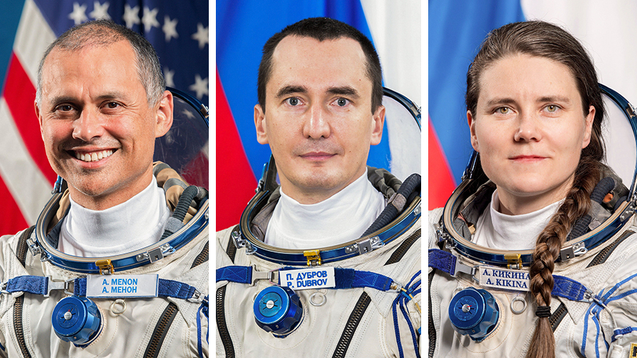 From left, NASA astronaut Anil Menon and Roscosmos cosmonauts Pyotr Dubrov and Anna Kikina pose for portraits wearing the Sokol launch and entry suits they wear aboard a Soyuz spacecraft.
