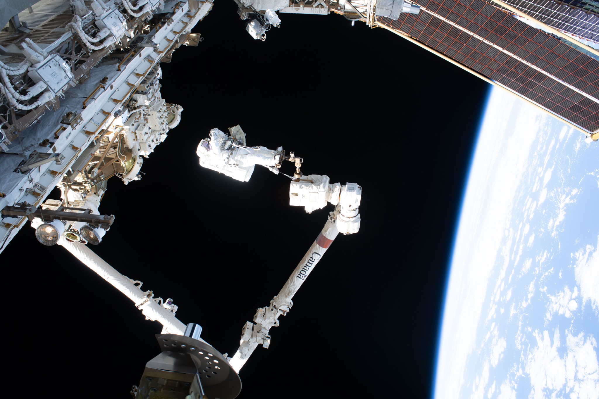 Expedition 75 commander Jessica Meir of NASA rides the Canadarm2 robotic arm during a spacewalk for navigation and science maintenance outside the International Space Station. Meir was attached to an articulating portable foot restraint installed on Canadarm2’s latching end effector. The orbital outpost was soaring 259 miles above the Pacific Ocean southwest of Mexico when this photograph was taken.