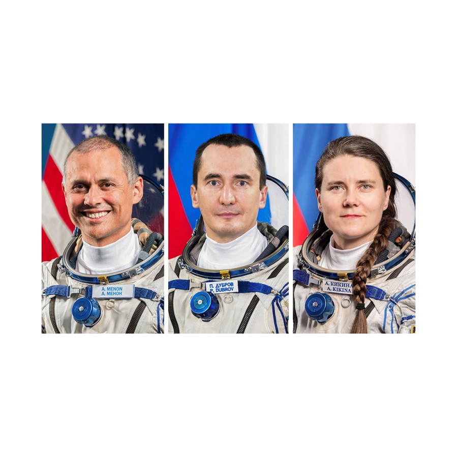 From left, NASA astronaut Anil Menon and Roscosmos cosmonauts Pyotr Dubrov and Anna Kikina pose for portraits wearing the Sokol launch and entry suits they wear aboard a Soyuz spacecraft.