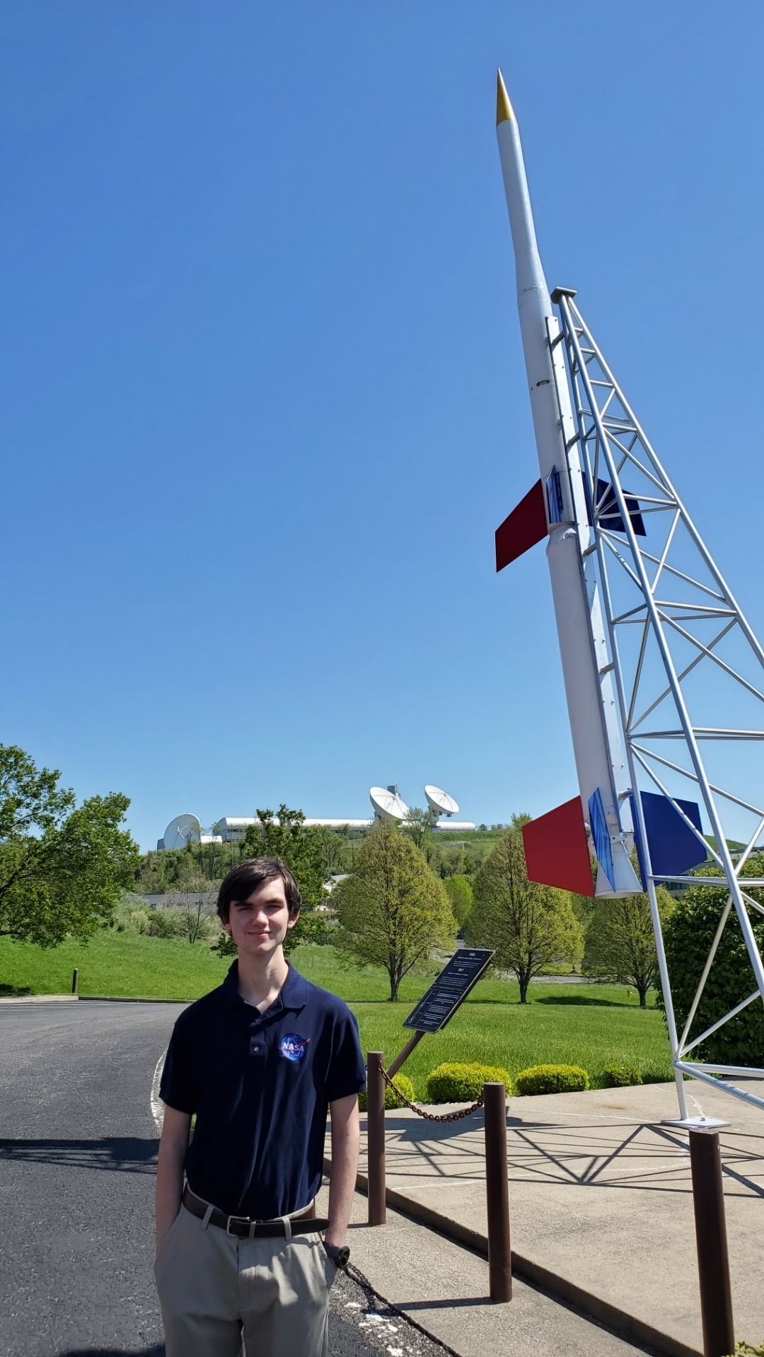 Fletcher Newell stands in front of a sounding rocket.