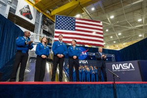 The four members of the Artemis II mission stand on stage after receiving the Congressional Space Medal of Honor. To their right is President Trump.
