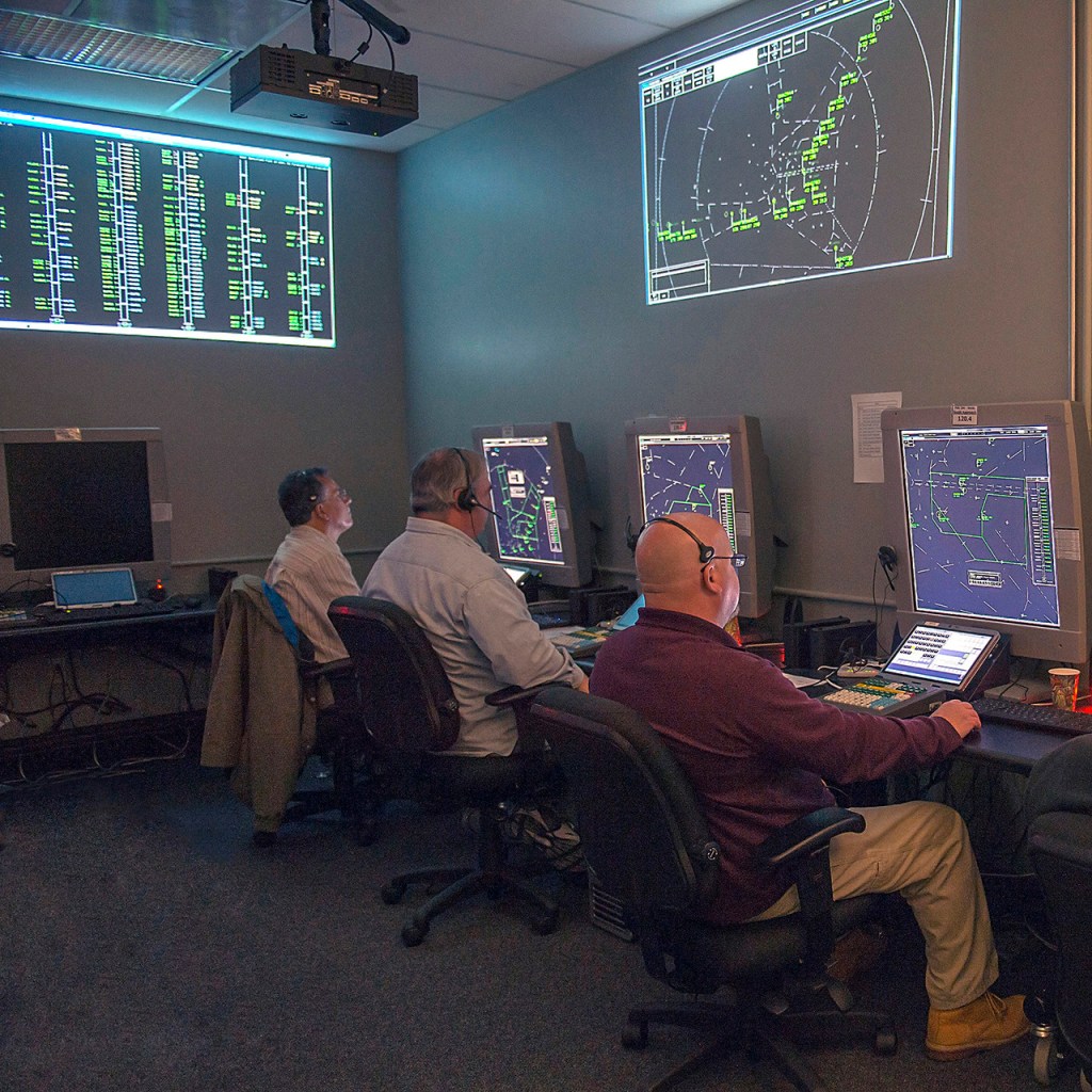 Research subjects participating in an air traffic control simulation in the Airspace Operations Laboratory (AOL) at NASA Ames Research Center as part of an Air Traffic Management Technology Demonstration 1 (ATD1) study.