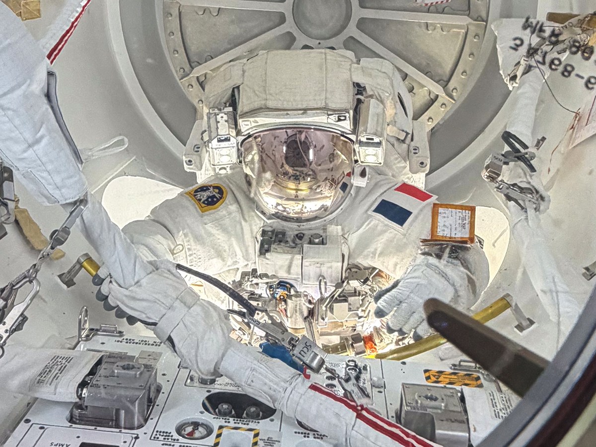 ESA astronaut Sophie Adenot is pictured inside the International Space Station's Quest airlock with her helmet visor down as she nears the end of a six‑hour, 23‑minute spacewalk on Aug. 18. 2026.