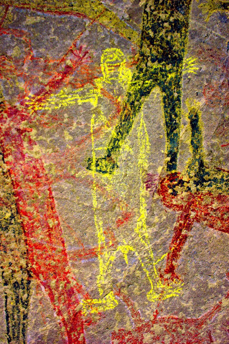 A new yellow figure emerges from behind the other after the dstretch algorithm is applied