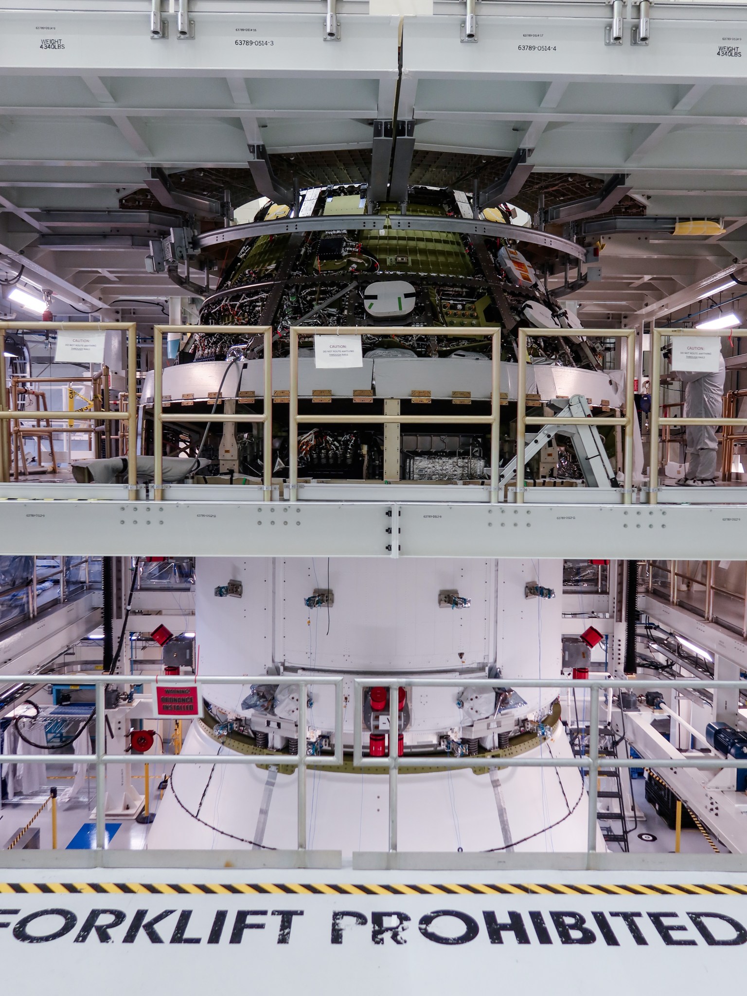 Orion spacecraft in an industrial high bay.