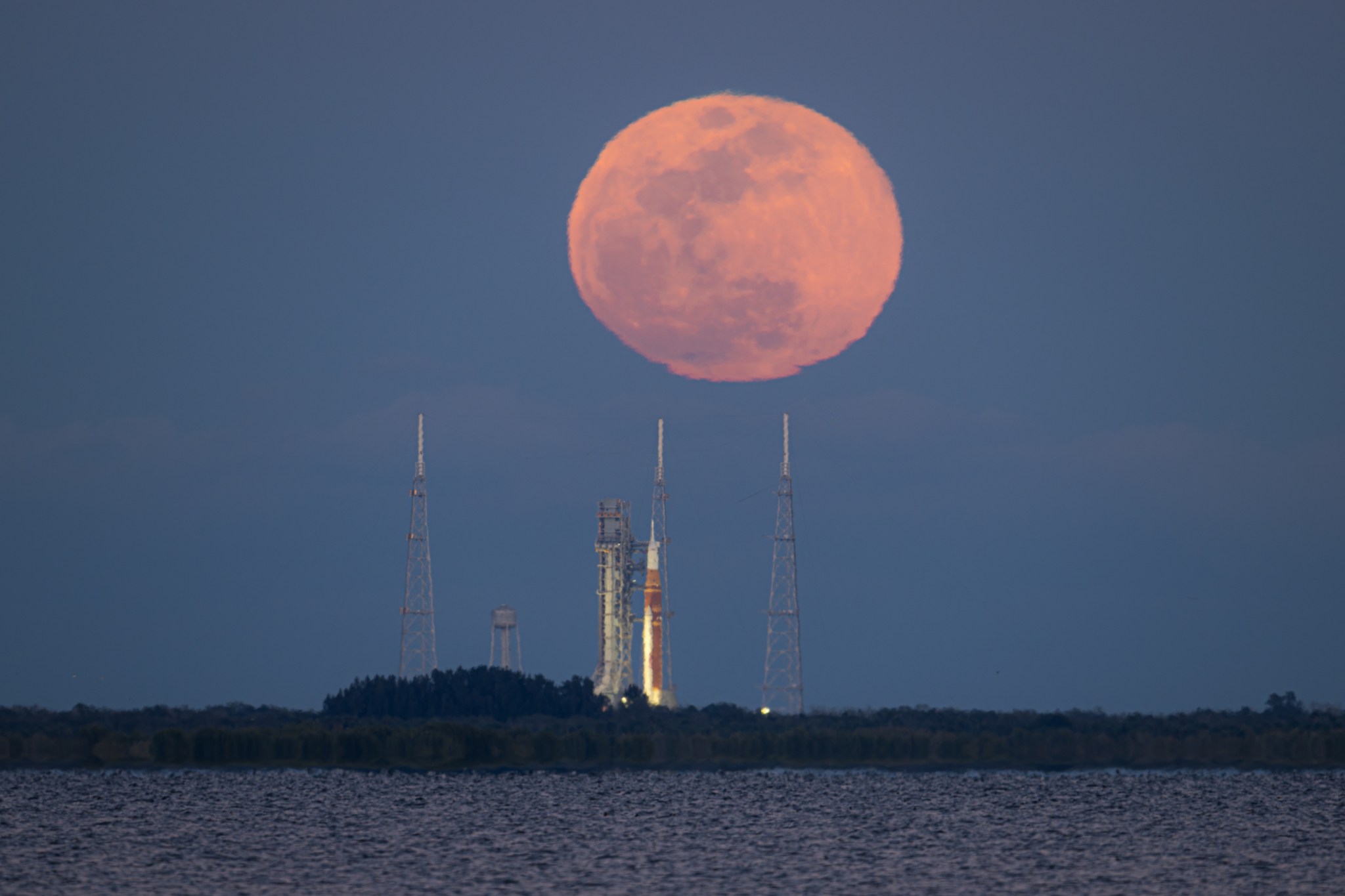 The full Moon rises behind NASA’s Artemis II Space Launch System (SLS) rocket and Orion spacecraft, on Sunday, Feb. 1, 2026, at NASA’s Kennedy Space Center. The Artemis II test flight, which launched in April 20206, took three NASA astronauts and one CSA (Canadian Space Agency) astronaut, around the Moon and back to Earth. Photo Credit: (NASA/John Kraus)