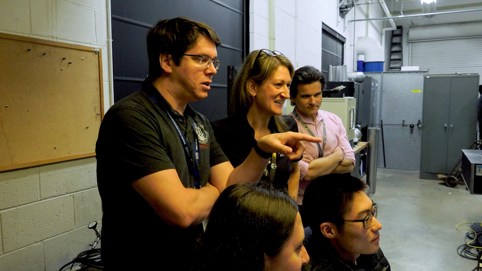 Clockwise from left: Wesley Chambers, deputy principal investigator for the PSI tests from Marshall’s Space Flight Center in Huntsville, Alabama; Ashley Korzun, test lead and principal investigator; Dave Lehotay, project manager; and Tylor Takahashi and Olivia Tyrrell, both from the SCALPSS instrument team, watch test footage in the control room.
