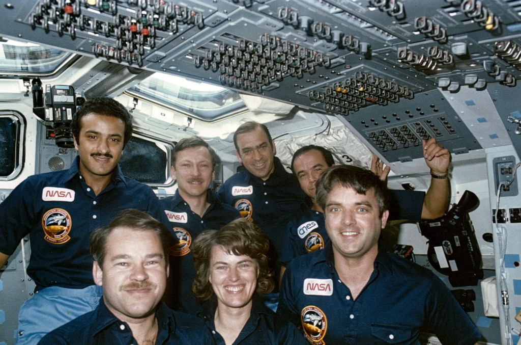 Group portrait on flight deck of all seven STS-51G crew members.