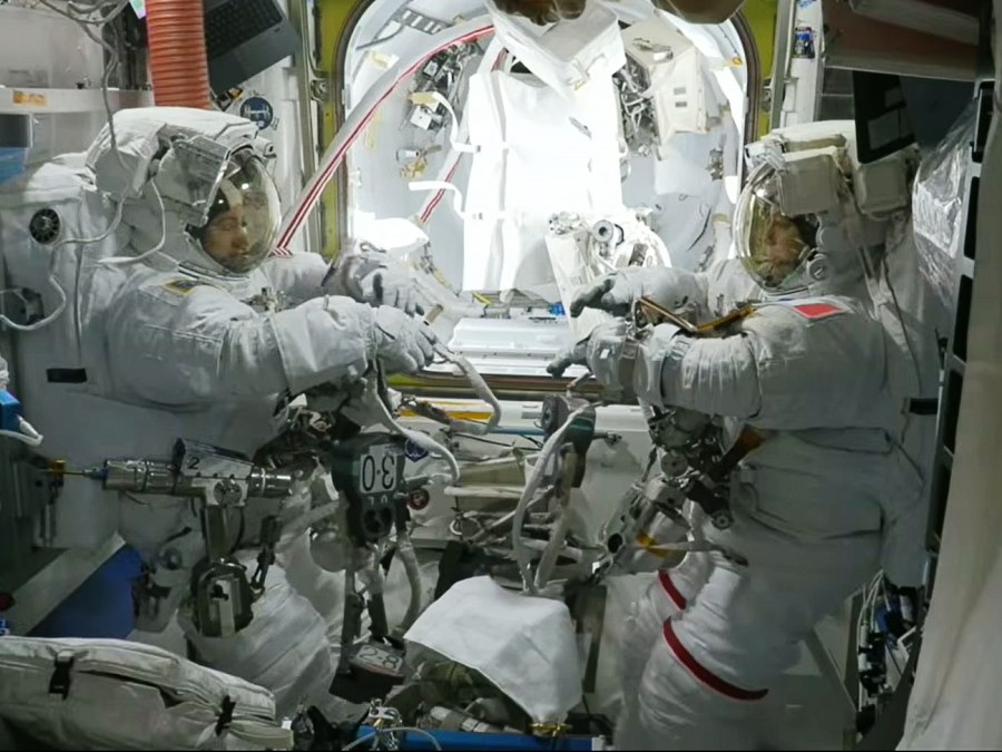 Astronauts Jessica Meir of NASA (left) and Sophie Adenot of ESA are suited up inside the Quest airlock preparing to exit the International Space Station for a spacewalk.