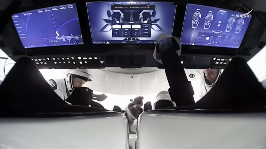 ESA astronaut Sophie Adenot (left) and Roscosmos cosmonaut Andrey Fedyaev are inside the SpaceX Dragon spacecraft preparing to undock from the International SPace Station.