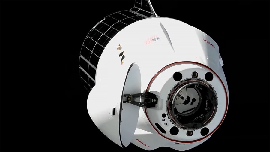 A SpaceX Dragon spacecraft approaches the International Space Station moments before docking to the Harmony module's space-facing port.