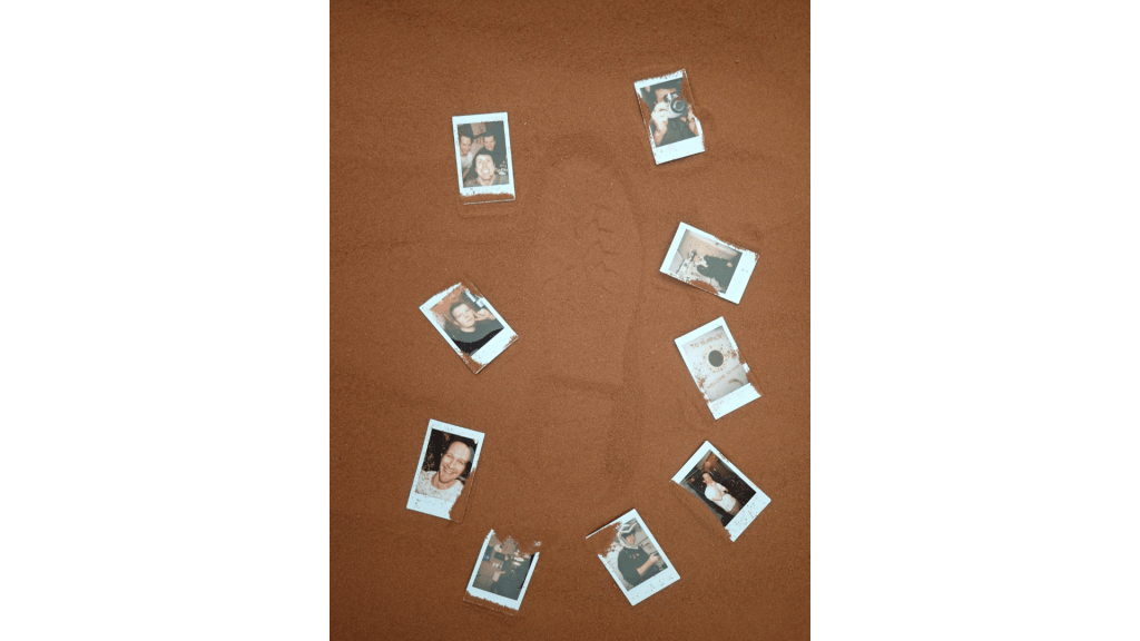Photos that the CHAPEA Mission 2 crew arranged around a boot print in the simulated Martian sand outside their habitat.