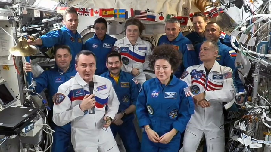 Roscosmos cosmonaut Pyotr Dubrov (front left) accepts command of the International Space Station from NASA astronaut Jessica Meir (front right) as the rest of the Expedition 75 crew looks on during a traditional change of command ceremony on Sunday, Oct. 4.