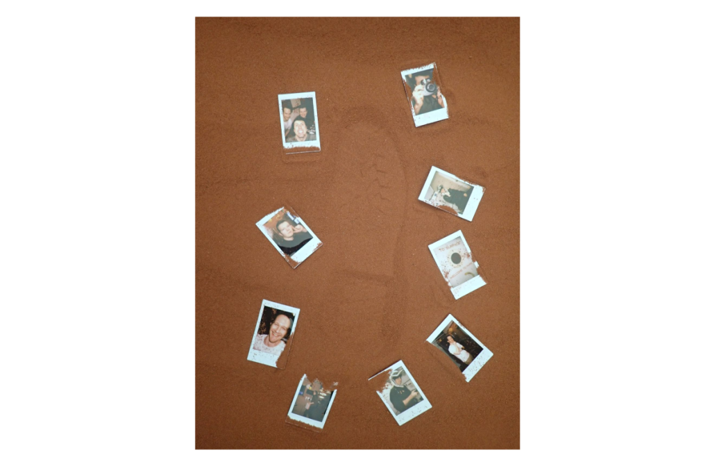 Photos that the CHAPEA Mission 2 crew arranged around a boot print in the simulated Martian sand outside their habitat.