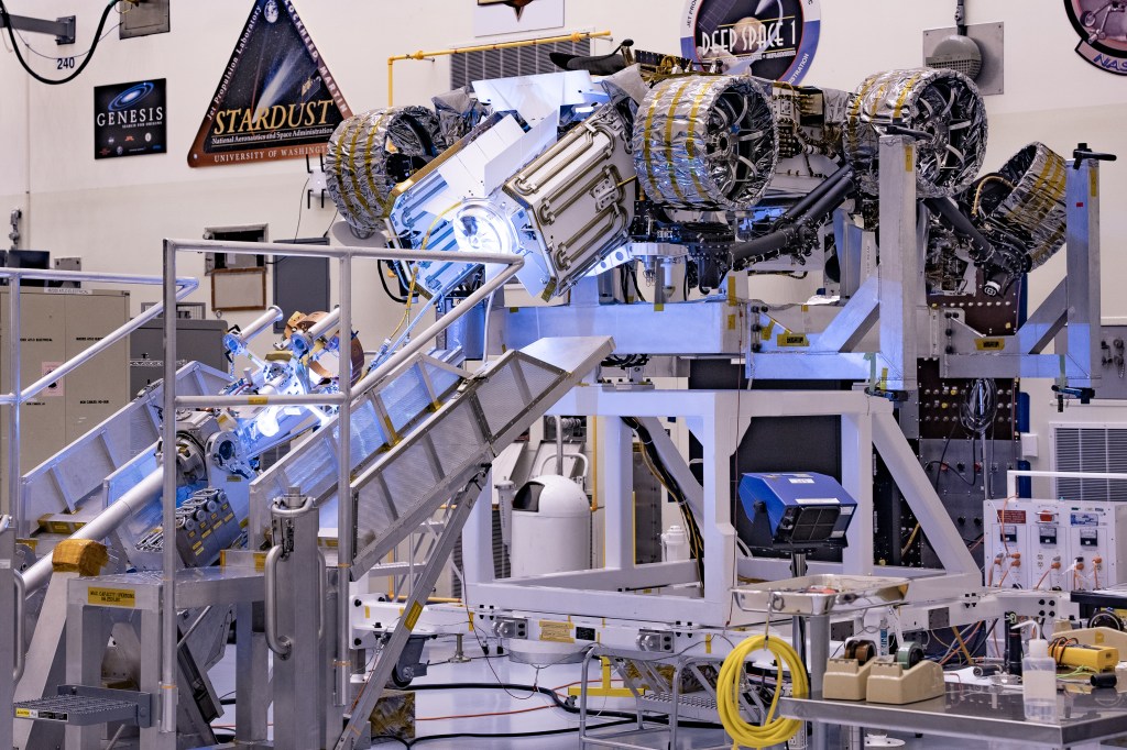 This image shows the Multi-Mission Radioisotope Thermoelectric Generator for NASA'S Mars 2020 Perseverance rover during a fit check with the rover in the payload processing facility at NASA's Kennedy Space Center in Florida on April 16-17, 2020. The Multi-Mission Radioisotope Thermoelectric Generator is a space nuclear power system that produces about 110 watts of electrical power to run the rover's systems and science instruments, and extra heat to keep them warm during the frigid Martian nights and winter seasons.