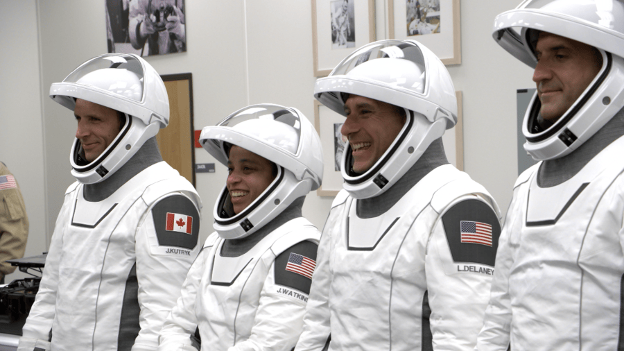 Four astronauts in white spacesuits.