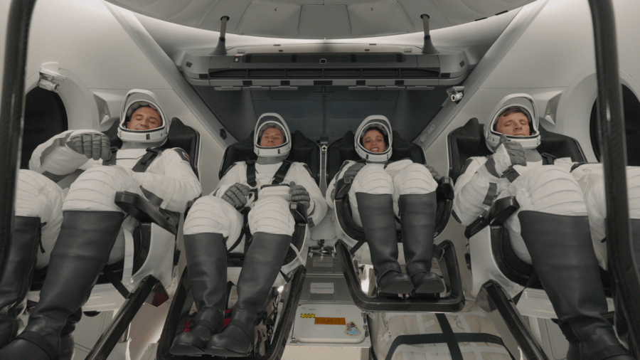 Four astronauts in a spacecraft.