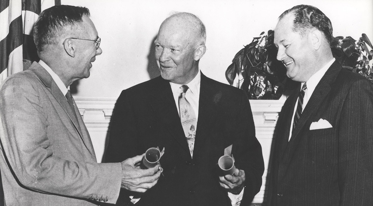 President Dwight Eisenhower (center) presents commissions to T. Keith Glennan (left) and Hugh L. Dryden (right), NASA's first administrator and deputy administrator respectively.