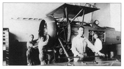 This photo shows NACA mechanics installing, in 1928, a cowling for testing.