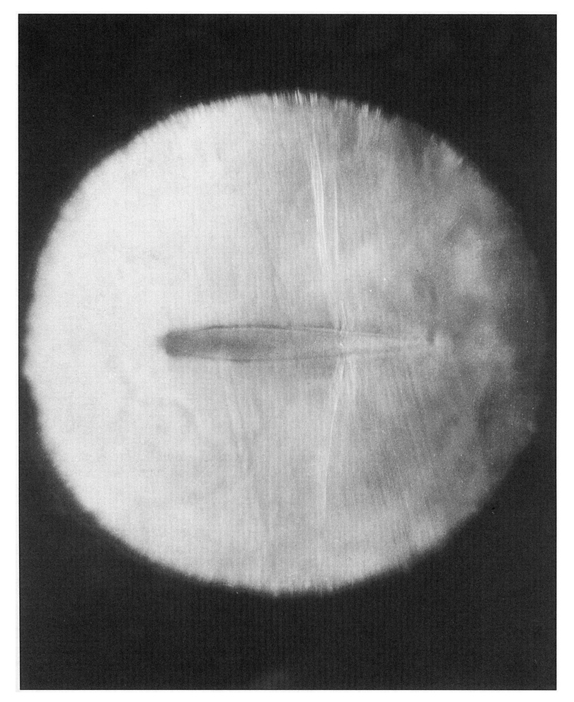 An early schlieren photograph of the shock pattern on an NACA 0012 airfoil in a freestream above the critical speed.