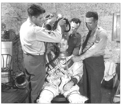 Photo Physicist Ray Wright wears a diving suit to protect himself while taking readings next to the operating slotted-tunnel.