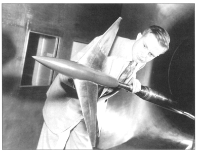 Whitcomb inspects a research model in the eight foot tunnel