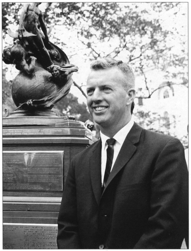 Photo of Dr Joseph A. Walker standing beside the 1961 Collier Trophy.