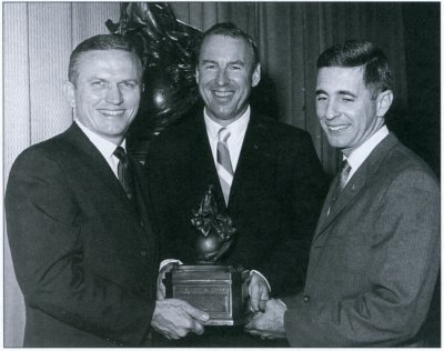 Photo of the flight crew of the Apollo 8 mission holding a small Collier Trophy.