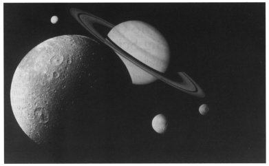 Photo montage of Saturn and four moons assembled from images taken by Voyager.
