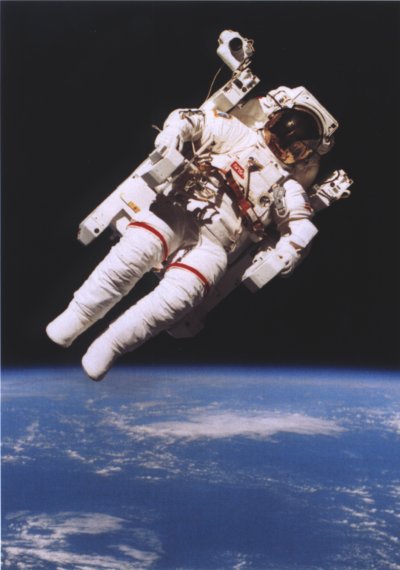 Photo of Bruce McCandless in the MMU flying at 45 degrees over the earth.