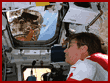 Apt uses a speaker mike unit to talk to the Mir space station