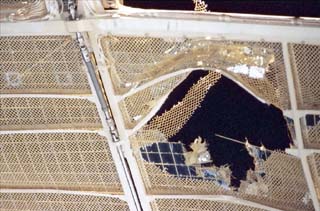 The damaged Spektr solar array, viewed from a window on the Mir Space Station during NASA-6. 