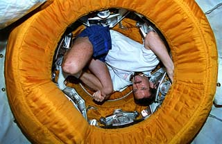 Hadfield curled up in hatch entry