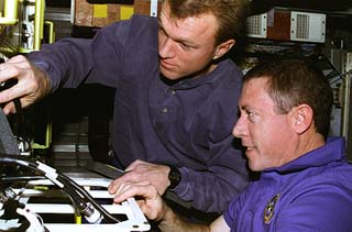 Baker and Jett work on equipment in hab 