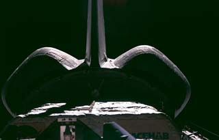 Sunlight reflects off the orbiter docking system (ODS) and the orbital maneuvering system (OMS) pods of the STS-81 orbiter Atlantis after its undocking from the Russian Mir space station. 