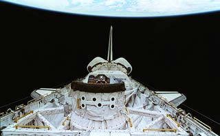 View of the orbiter docking system (ODS) in the Atlantis's payload bay as seen from the aft flight deck windows. These photos were taken prior to docking with the Russian space station Mir. 