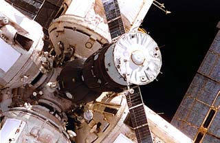 Soyuz spacecraft docking to the Mir space station central node. 