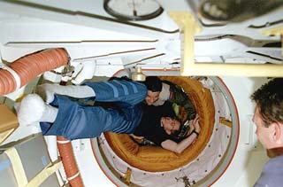 STS-81 mission commander Michael Baker is greeted by Mir-22 commander Valeri Korzun.