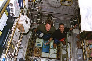 Mission specialists Michael Foale and Jean-Francois Clervoy pose for the camera in the Spacehab module. 