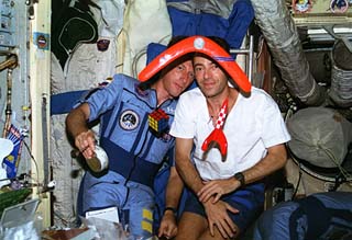 Candid views of STS-84 crewmembers in the Mir Space Station Base Block including Michael Foale (left) and Jean-Francois Clervoy.
