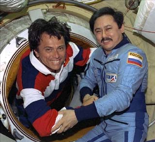 Mission Specialist Franklin Chang-Diaz greets Mir-25 commander Talgat Musabayev at the Docking Module hatch.