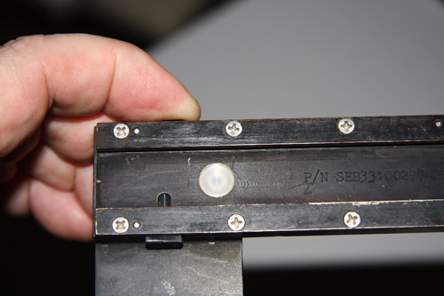DAC fitting on right angle bracket with button
                  depressed