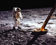 Aldrin stands beside LM strut and probe