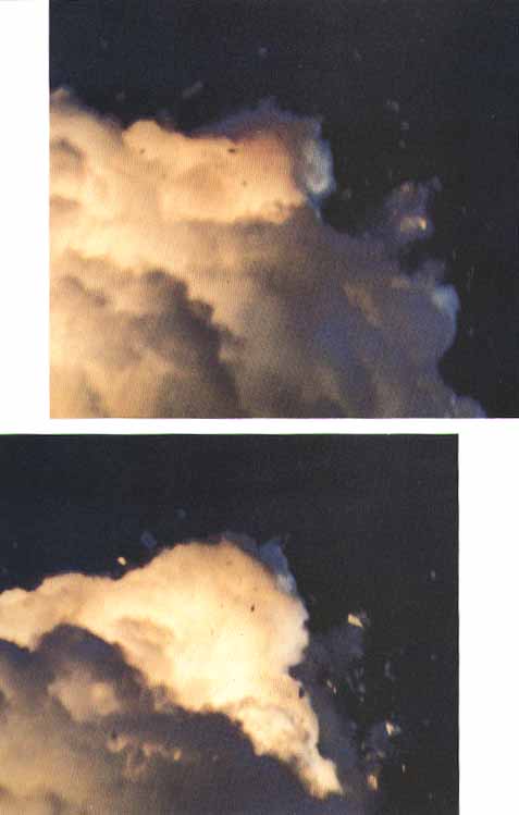 At about 76 seconds, unidentifiable fragments of the Shuttle vehicle can be seen tumbling against a background of fire, smoke and vaporized propellants from the External Tank (left). 