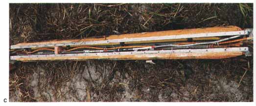 Photo C: The lower photos show the range safety destruct charges in the External Tank. These charges were exonerated when they were recovered intact and undetonated.

