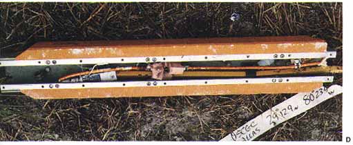 Photo D: The lower photos show the range safety destruct charges in the External Tank. These charges were exonerated when they were recovered intact and undetonated.