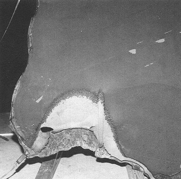 Photograph 7. Interior View of Burned Edge of SSC No. 712. Note Taper of Edge Indicating Burn Through from the Inside to the Outside.