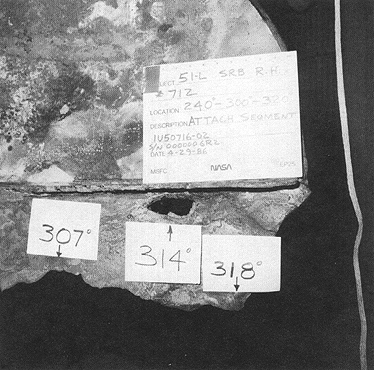 Photograph 8. Exterior View of Small Hole in Inverted SSC No. 712. Note Inward Taper Indicating Burn Through from the Outside to the Inside.