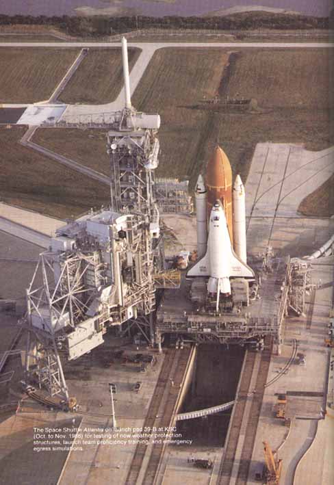 The space shuttle Atlantis on launch pad 39-B at KSC (Oct. to Nov. 1986) for testing of new weather protection structures, launch team proficiency training and emergency egress simulations.